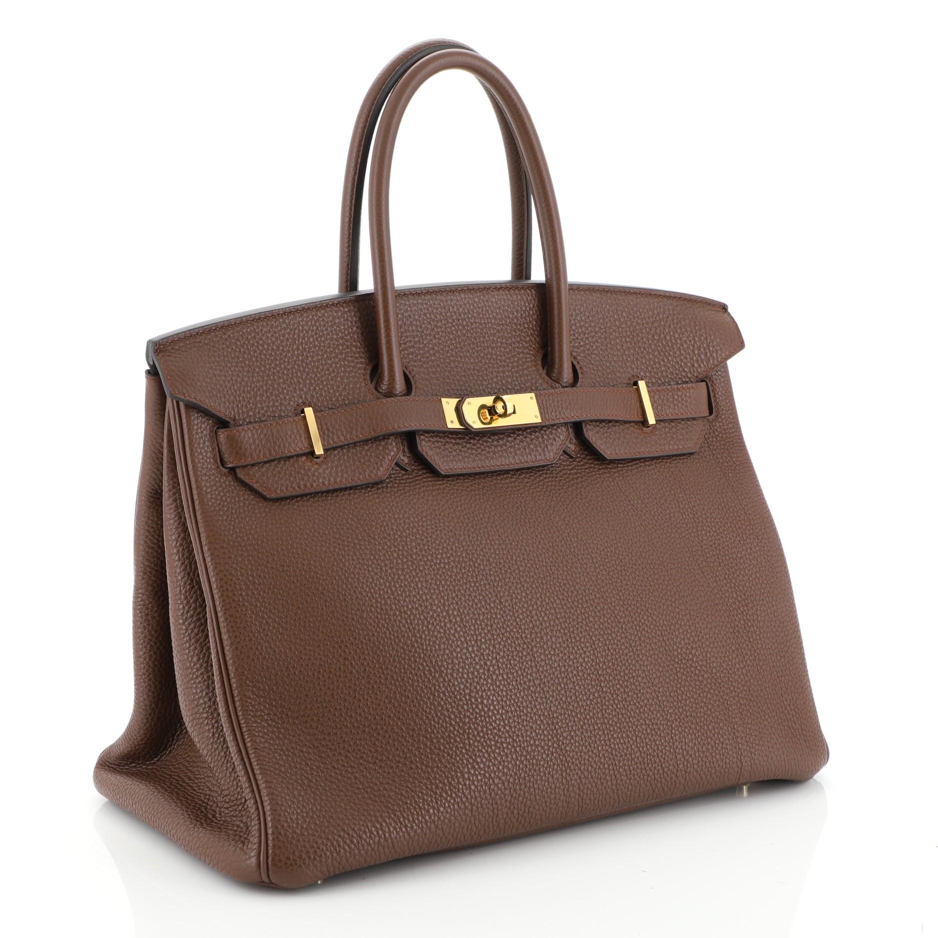 This Hermes Birkin Handbag Brulee Togo with Gold Hardware 35, crafted in Brulee brown Togo leather, features dual rolled top handles, frontal flap, and gold hardware. Its turn-lock closure opens to a Brulee brown Chevre leather interior with zip and