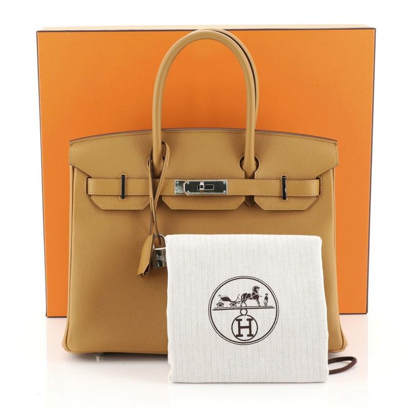 This Hermes Birkin Handbag Caramel Epsom with Palladium Hardware 30, crafted in Caramel brown Epsom leather, features dual rolled top handles, frontal flap, and palladium hardware. Its turn-lock closure opens to a Caramel brown Chevre leather