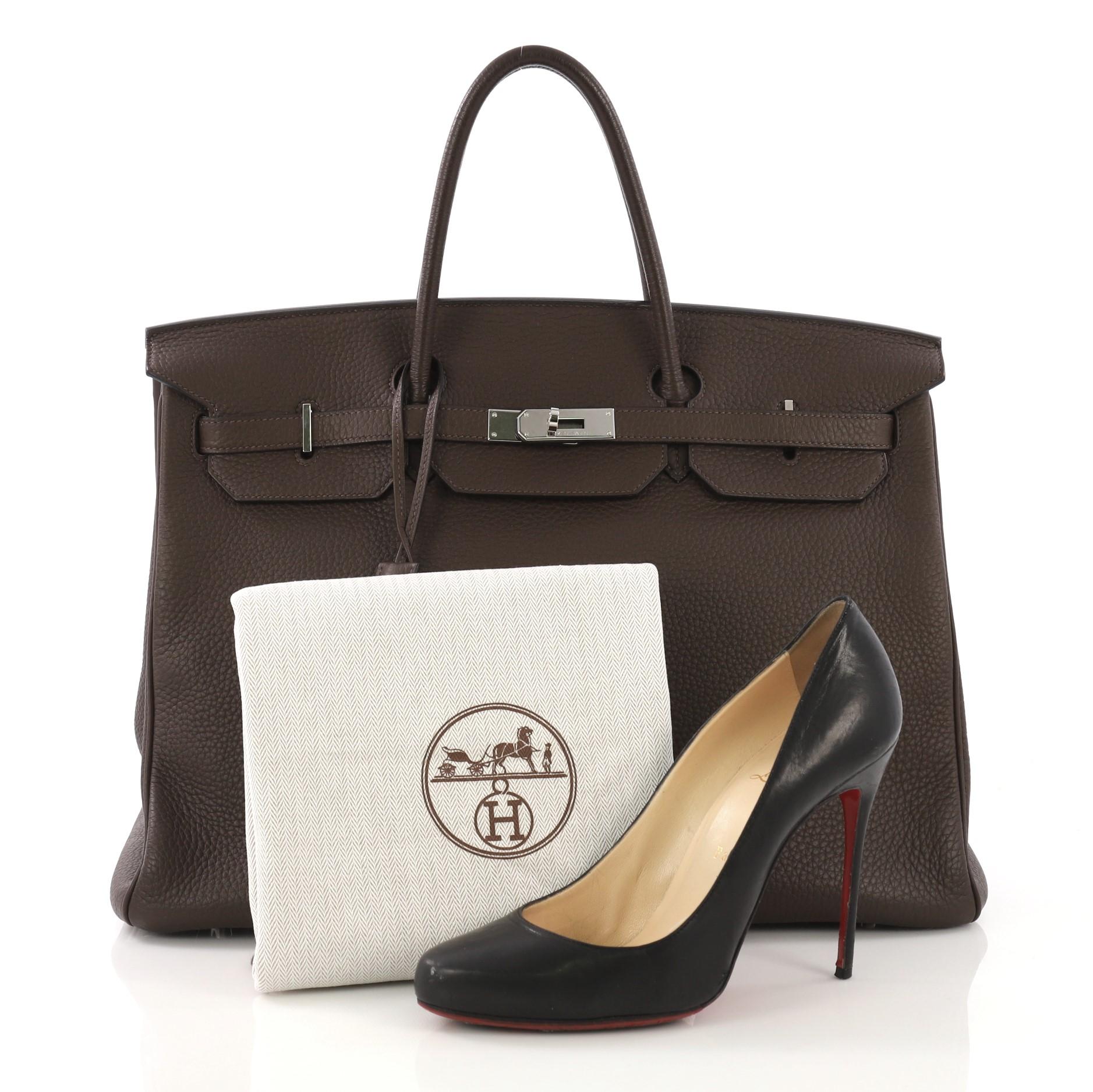 This Hermes Birkin Handbag Chocolat Clemence with Palladium Hardware 40, crafted in Chocolat brown Clemence leather, features dual rolled handles, a frontal flap, and palladium hardware. Its turn-lock closure opens to a Chocolat brown Chevre leather