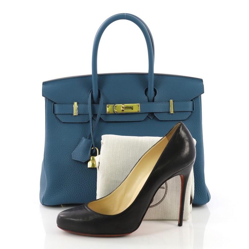 This Hermes Birkin Handbag Cobalt Togo With Gold Hardware 30, crafted in Cobalt blue Togo leather, features dual rolled handles, front flap, and gold hardware. Its turn-lock closure opens to a Cobalt blue Chevre leather interior with slip pocket.