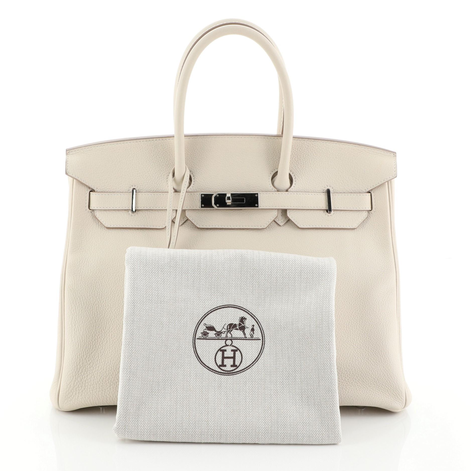 This Hermes Birkin Handbag Craie Togo with Palladium Hardware 35, crafted in Craie neutral Togo leather, features dual rolled handles, frontal flap, and palladium hardware. Its turn-lock closure opens to a Craie neutral Chevre leather interior with