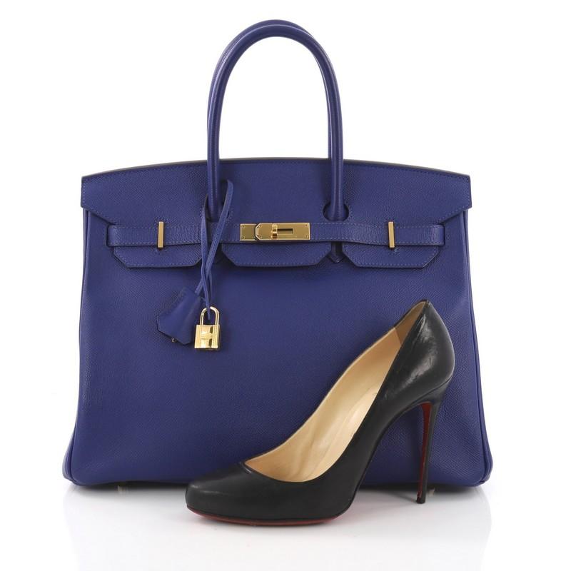 This Hermes Birkin Handbag Electric Blue Epsom with Gold Hardware 35, crafted in electric blue epsom leather, features dual rolled handles, front flap and gold-tone hardware. Its turn-lock closure opens to a blue leather interior with zip and slip