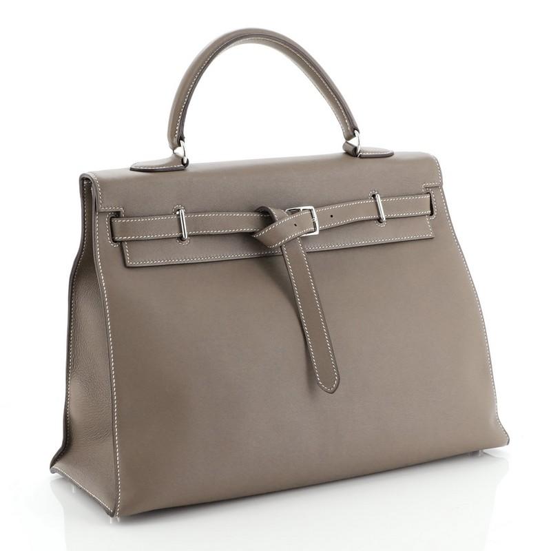 This Hermes Birkin Handbag Etain Epsom with Palladium Hardware 35, crafted in Etain grey Epsom leather, features dual rolled handles, frontal flap, and palladium hardware. Its turn-lock closure opens to an Etain grey Chevre leather interior with zip
