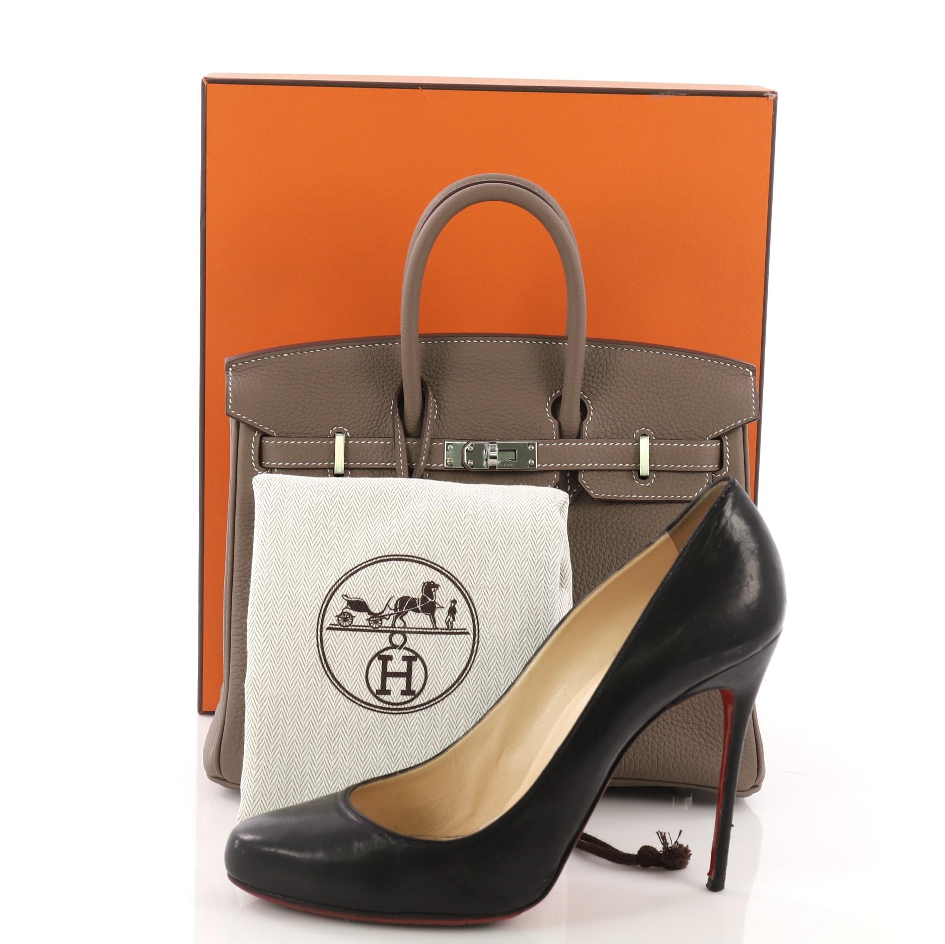This Hermes Birkin Handbag Etoupe Togo with Palladium Hardware 25, crafted in Etoupe taupe Togo leather, features dual rolled top handles, frontal flap, and palladium hardware. Its turn-lock closure opens to an Etoupe Chevre leather interior with