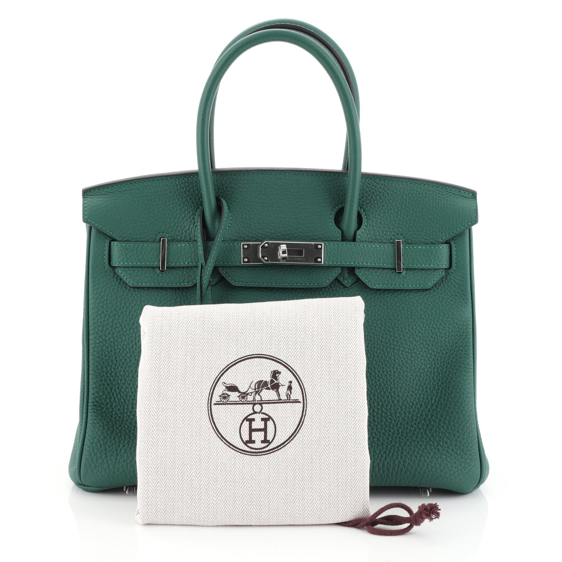 This Hermes Birkin Handbag Malachite Togo with Palladium Hardware 30, crafted in Malachite green Togo leather, features dual rolled handles, frontal flap, and palladium hardware. Its turn-lock closure opens to a Malachite green Chevre leather