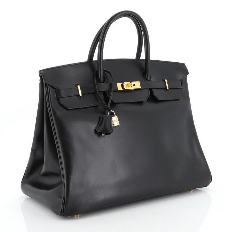 This Hermes Birkin Handbag Noir Box Calf with Gold Hardware 40, crafted in Noir black Box Calf leather, features dual rolled handles, frontal flap, and gold hardware. Its turn-lock closure opens to a Noir black Chevre leather interior with zip and
