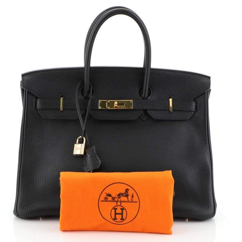 This Hermes Birkin Handbag Noir Clemence with Gold Hardware 35, crafted in Noir black Clemence leather, features dual rolled handles, frontal flap, and gold hardware. Its turn-lock closure opens to a Noir black Chevre leather interior with zip and