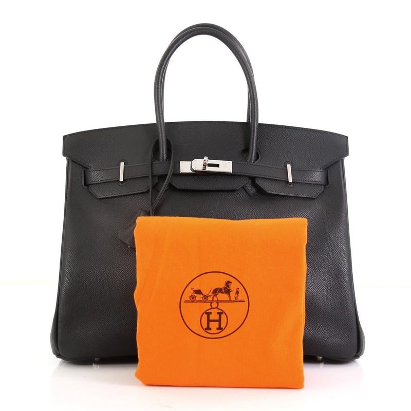 This Hermes Birkin Handbag Noir Epsom with Palladium Hardware 35, crafted in Noir black Epsom leather, features dual rolled handles, frontal flap, and palladium hardware. Its turn-lock closure opens to a Noir black leather interior with zip and slip