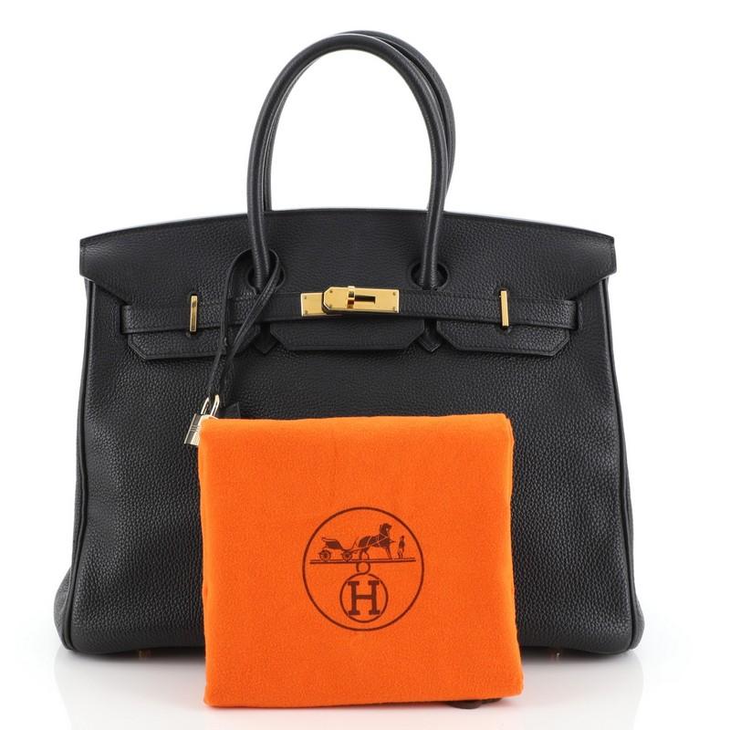 This Hermes Birkin Handbag Noir Togo with Gold Hardware 35, crafted in Noir black Togo leather, features dual rolled handles, frontal flap, and gold hardware. Its turn-lock closure opens to a Noir black Chevre leather interior with zip and slip