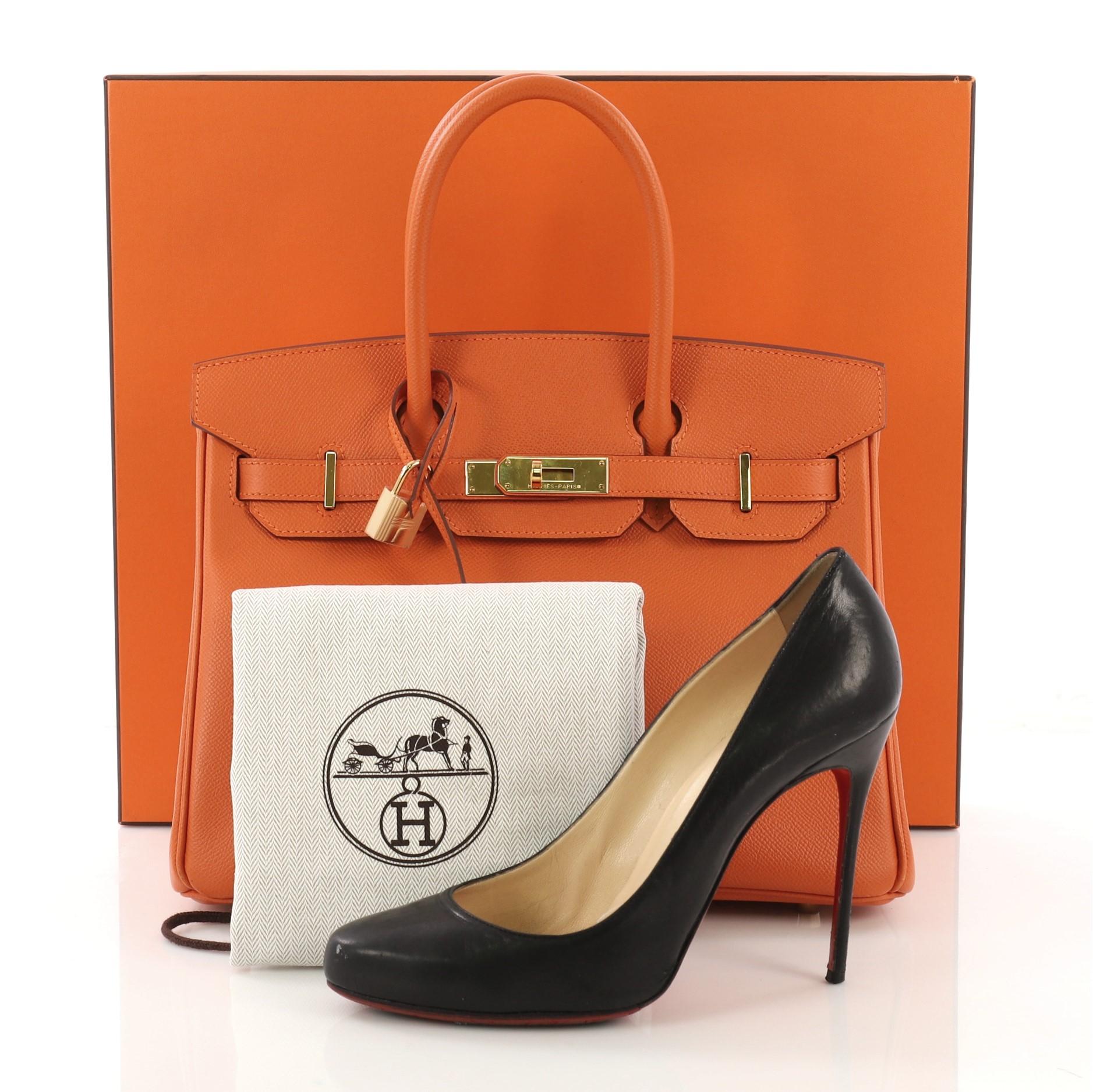 This Hermes Birkin Handbag Orange H Epsom with Gold Hardware 30, crafted in Orange H orange Epsom leather, features dual rolled top handles, frontal flap, and gold hardware. Its turn-lock closure opens to an Orange H orange Chevre leather interior