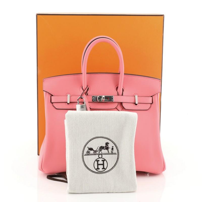 This Hermes Birkin Handbag Rose Lipstick Swift with Palladium Hardware 25, crafted in Rose Lipstick pink Swift leather, features dual rolled handles, frontal flap, and palladium hardware. Its turn-lock closure opens to a Rose Lipstick pink Swift