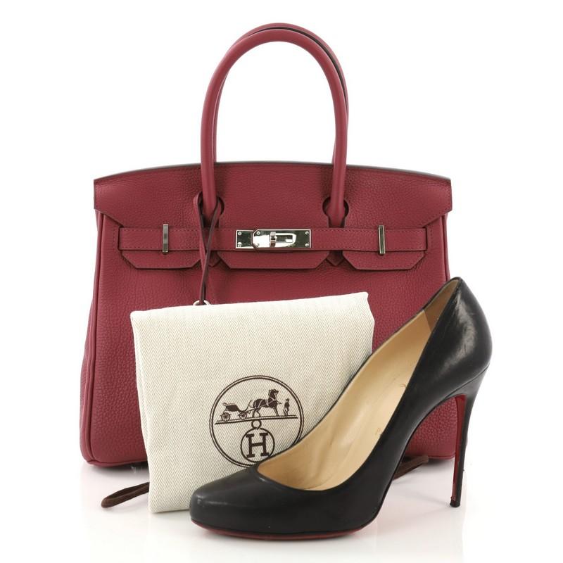 This Hermes Birkin Handbag Rouge Grenat Togo with Palladium Hardware 30, crafted from Rouge Grenat red Togo leather, features dual rolled handles, front flap, and palladium hardware. Its turn-lock closure opens to a Rouge Grenat Chevre leather