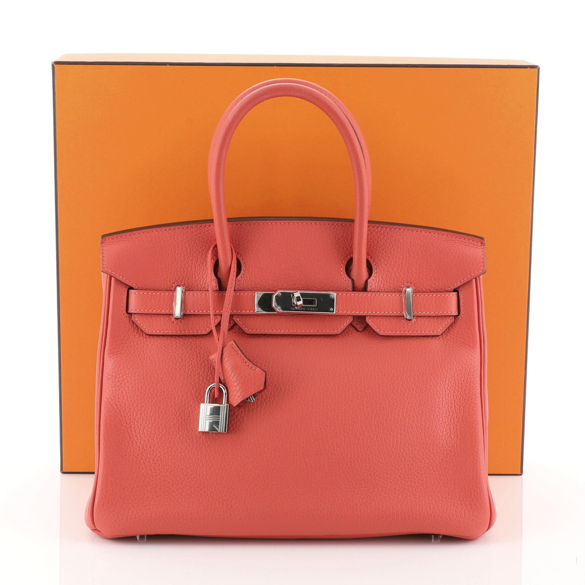 This Hermes Birkin Handbag Rouge Pivoine Clemence with Palladium Hardware 30, crafted in Rouge Pivoine red Clemence leather, features dual rolled handles, frontal flap, and palladium hardware. Its turn-lock closure opens to a Rouge Pivoine red