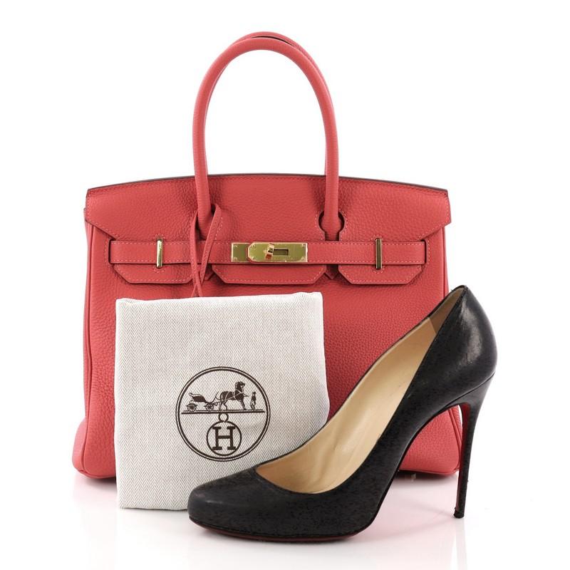 This Hermes Birkin Handbag Rouge Pivoine Togo With Gold Hardware 30, crafted in Rouge Pivoine pink togo leather, features dual rolled handles, front flap, and gold-tone hardware. Its turn-lock closure opens to a matching pink leather interior with