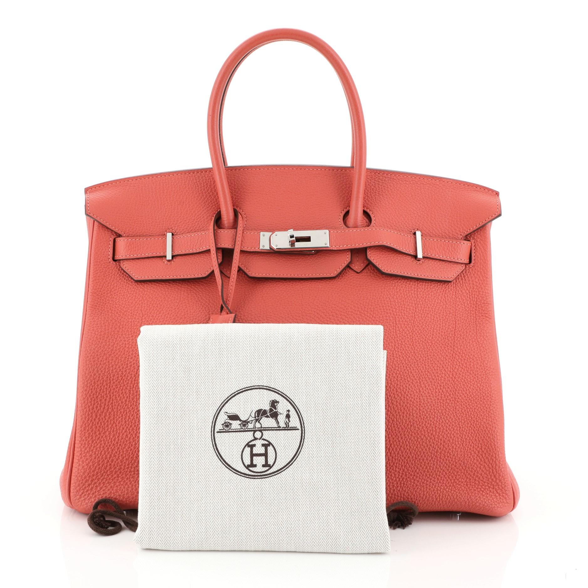 This Hermes Birkin Handbag Rouge Pivoine Togo with Palladium Hardware 35, crafted in Rouge Pivoine red Togo leather, features dual rolled handles, frontal flap, and palladium hardware. Its turn-lock closure opens to a Rouge Pivoine red Chevre