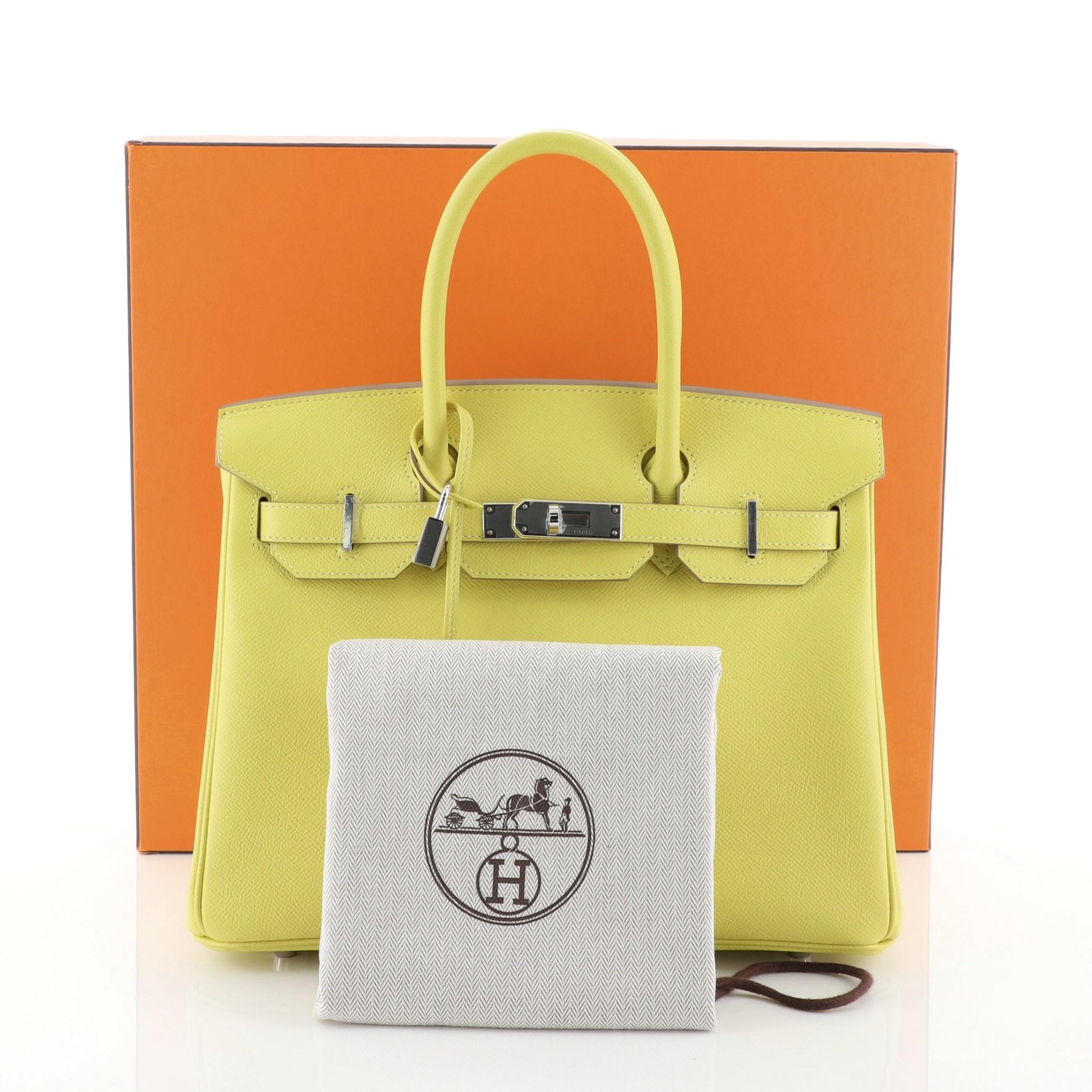 This Hermes Birkin Handbag Soufre Epsom with Palladium Hardware 30, crafted in Soufre yellow Epsom leather, features dual rolled top handles, frontal flap, and palladium hardware. Its turn-lock closure opens to a Soufre yellow Chevre leather