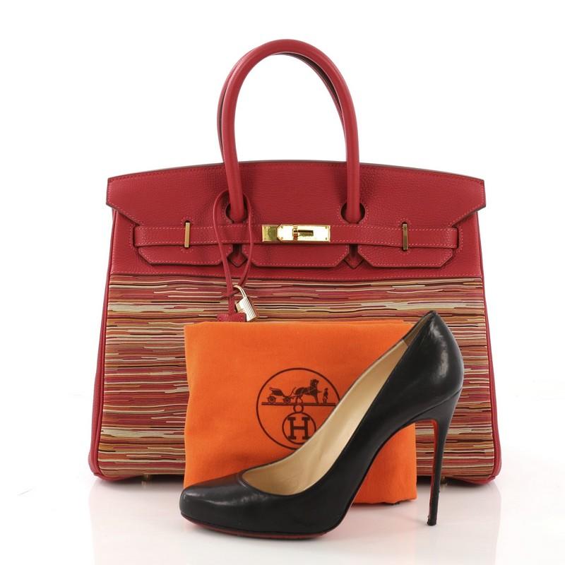 This Hermes Birkin Handbag Vibrato and Togo 35, crafted in Rouge Vif red Togo leather and Multicolor Vibrato, features dual rolled handles, frontal flap, and gold hardware. Its turn-lock closure opens to a Rouge Vif red Chevre leather interior with