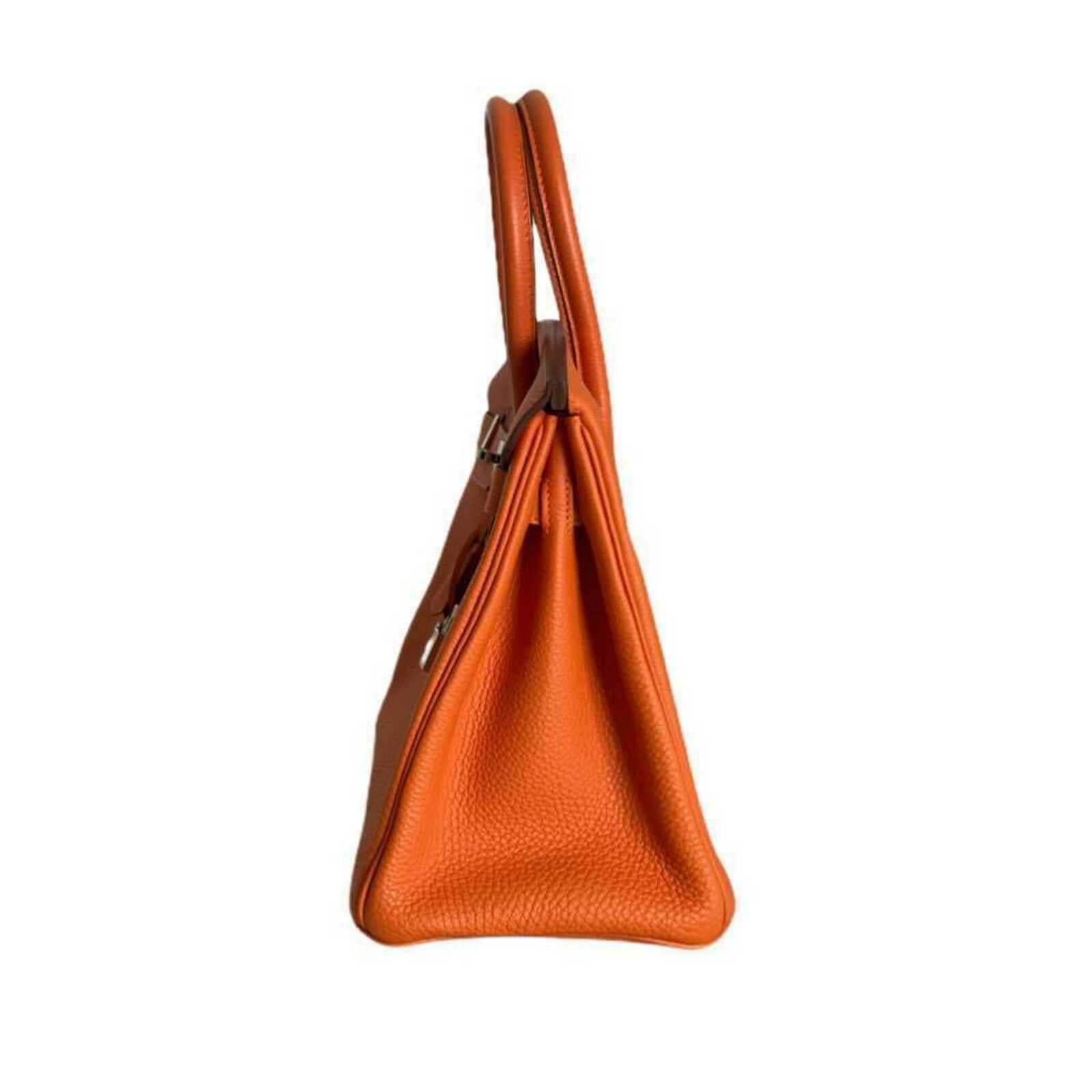 - Designer: HERMÈS
- Model: Birkin
- Condition: Very good condition.
- Accessories: Padlock, Keys
- Measurements: Width: 30 cm, Height: 22cm, Depht: 16 cm
- Exterior Material: Leather
- Exterior Color: Orange
- Hardware Color: Silver
- Serial