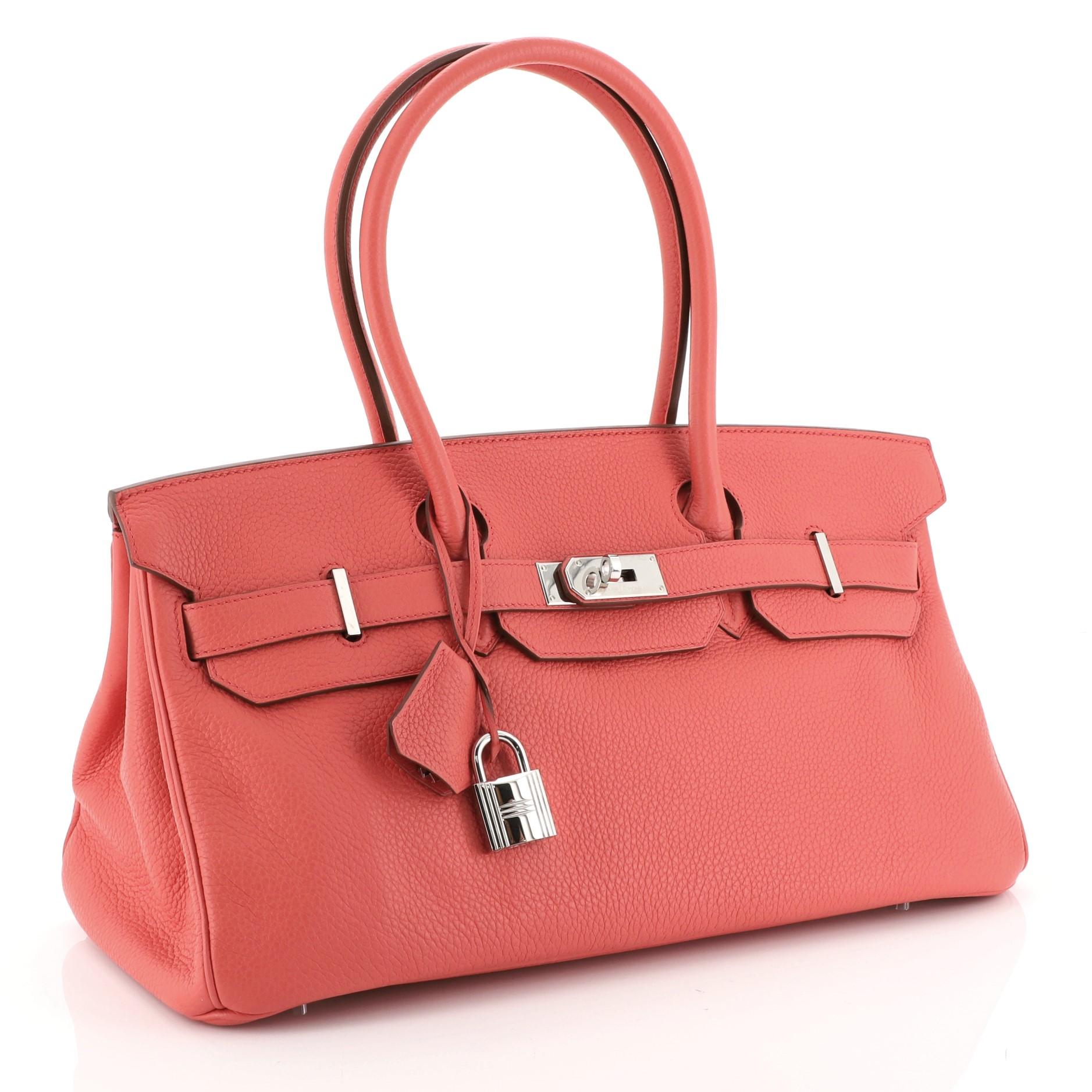This Hermes Birkin JPG Handbag Bougainvillea Clemence with Palladium Hardware 42, crafted in Bougainvillea red Clemence leather, features dual rolled handles, frontal flap, and palladium hardware. Its turn-lock closure opens to a Bougainvillea red