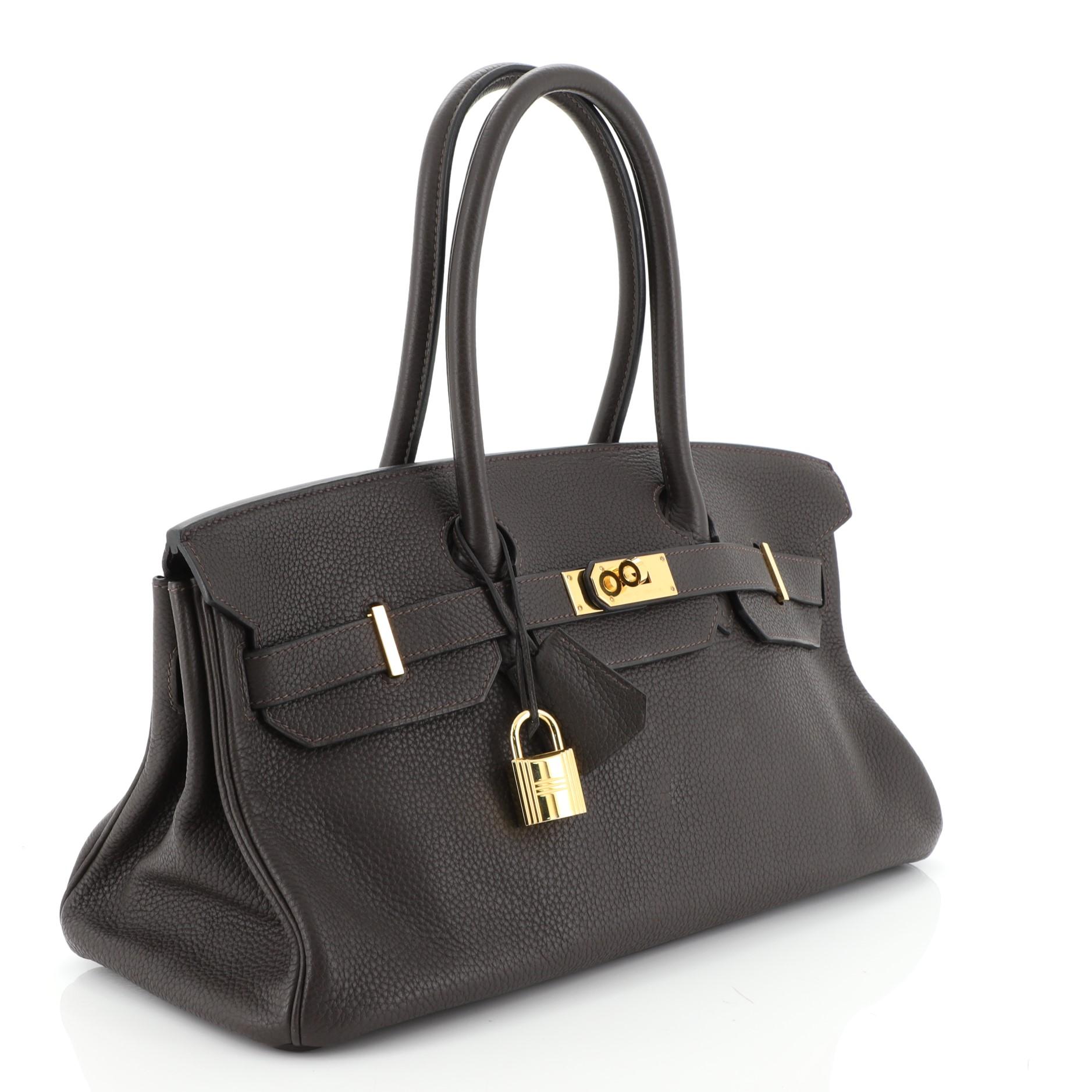 This Hermes Birkin JPG Handbag Cafe Clemence with Gold Hardware 42, crafted in Cafe Brown Clemence leather, features dual rolled top handles, frontal flap, and gold hardware. Its turn-lock closure opens to a Cafe brown Chevre leather interior with