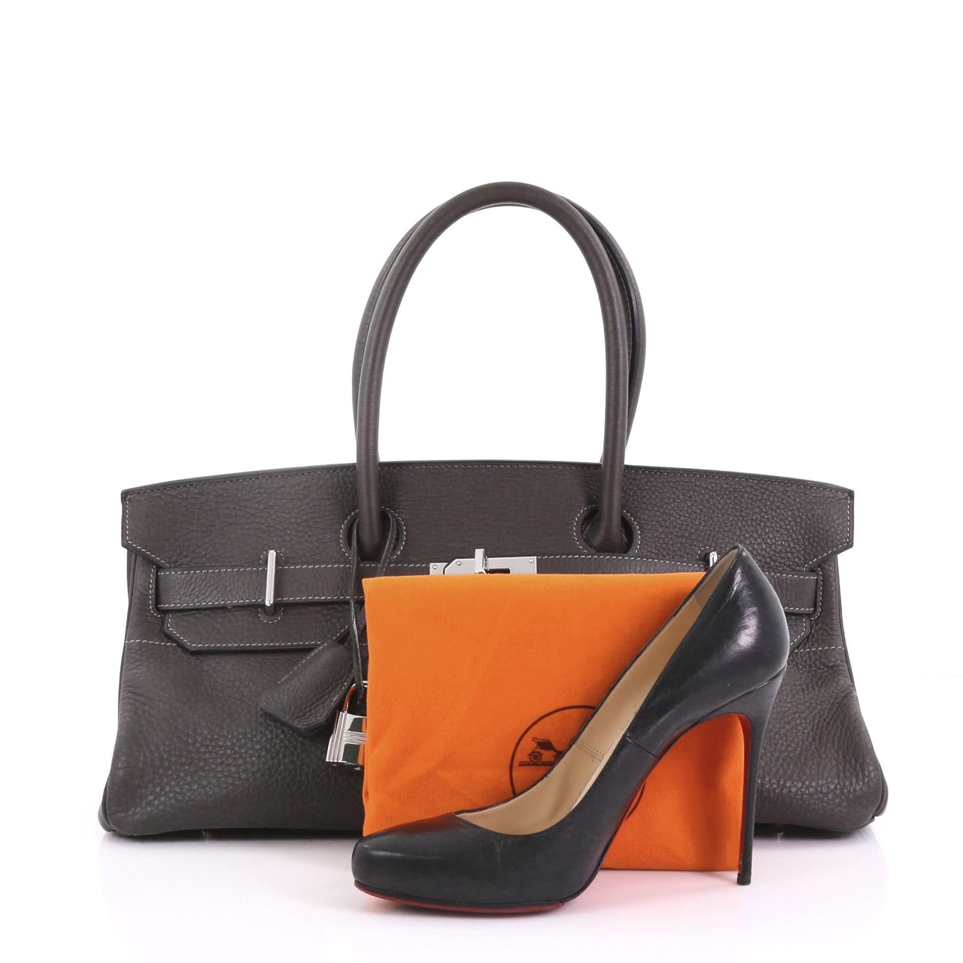 This Hermes Birkin JPG Handbag Graphite Clemence with Palladium Hardware 42, crafted in Graphite dark grey Clemence leather, features dual rolled handles, front flap and palladium hardware. Its turn-lock closure opens to a Graphite grey Chevre