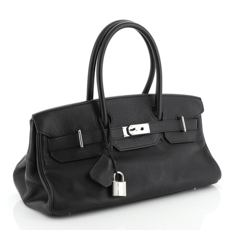 This Hermes Birkin JPG Handbag Noir Clemence with Palladium Hardware 42, crafted from Noir black Clemence leather, features dual rolled leather handles, frontal flap, and palladium hardware. Its turn-lock closure opens to a Noir black Chevre leather