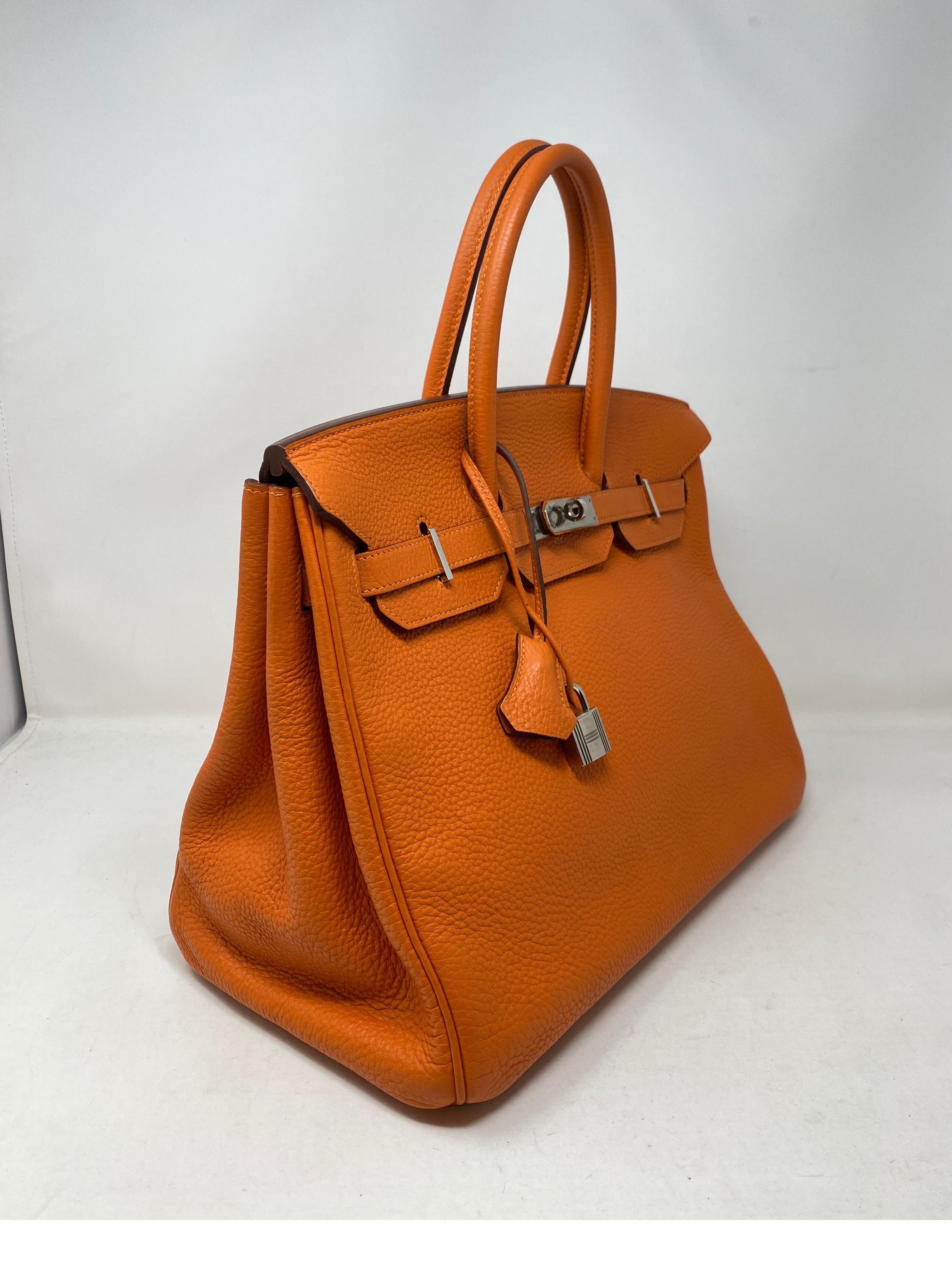 Hermes Birkin Orange 35 Bag. Palladium hardware. Classic orange color. Excellent condition. Includes clochette, lock, keys, and dust cover. Guaranteed authentic. 