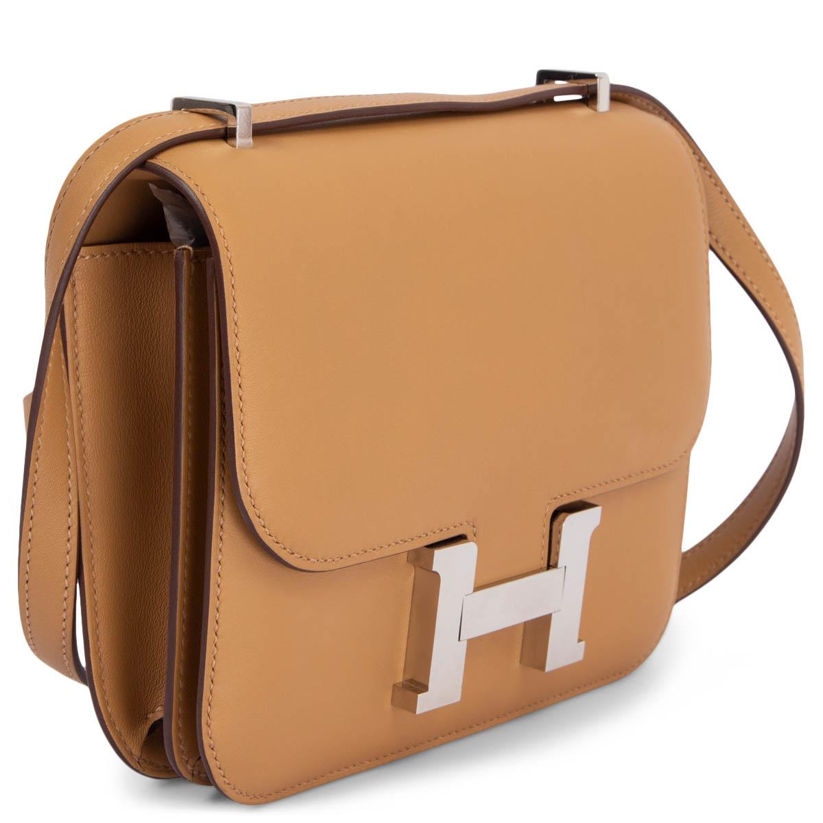 100% authentic Hermès Constance 18 mini shoulder bag in Biscuit Swift leather. Palladium H-Buckle closure. Lined in Veau Swift leather. Inside is divided into two compartments with an open pocket against the front and back. Has been carried and