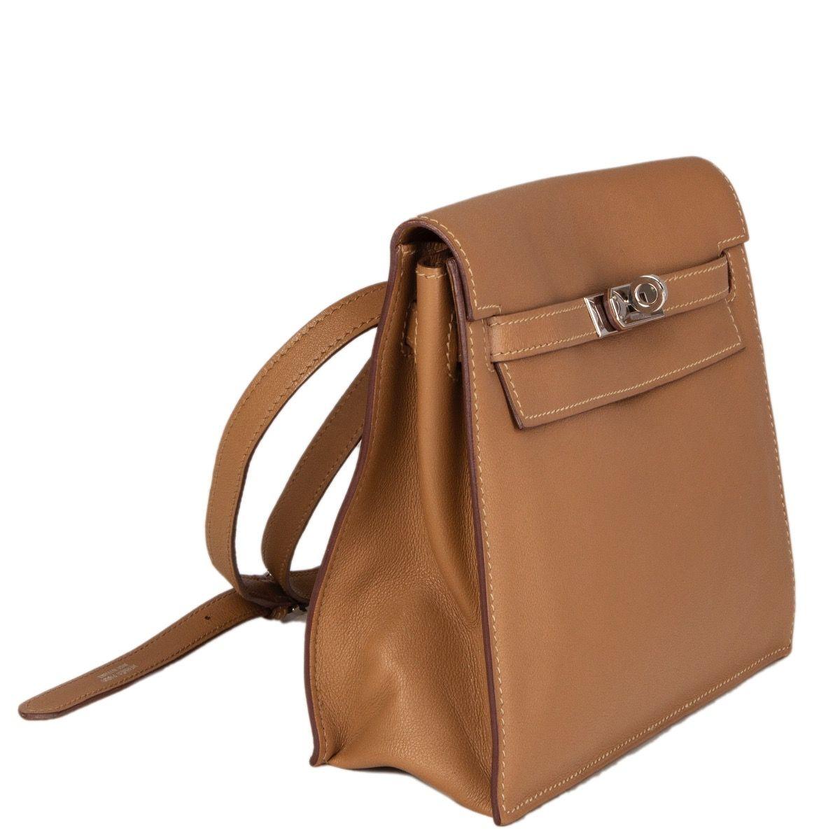 Hermès 'Kelly Danse' crossbody or belt bag in Biscuit (beige) Veau Swift leather. Opens with a Palladium Kelly-Buckle. Lined in Veau swift leather with one open pocket against the back. Comes with a adjustable shoulder strap. Has been carried and is