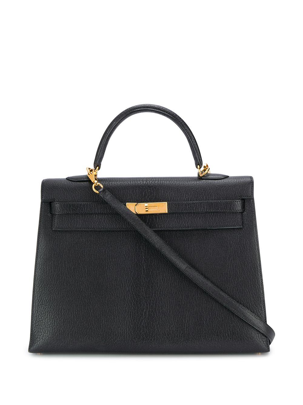 Crafted in France from pure black Chevre de Coromandel, a soft goat hide leather, popular for its lightweight and scratch-resistant texture, this pre-loved, 35cm Kelly Sellier bag features a medium, round top-handle, an adjustable crossbody shoulder