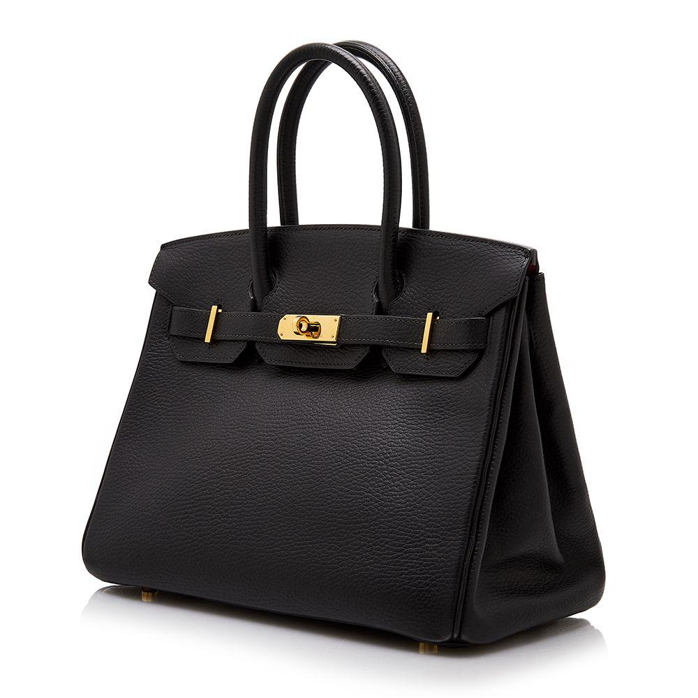 Adding a twist to the traditional Hermès Birkin, this truly spectacular, one-of-a-kind rarity combines an bold black Ardennes leather exterior with a contrasting red interior and gold-tone metal accents, for an effect that is unexpectedly modern and