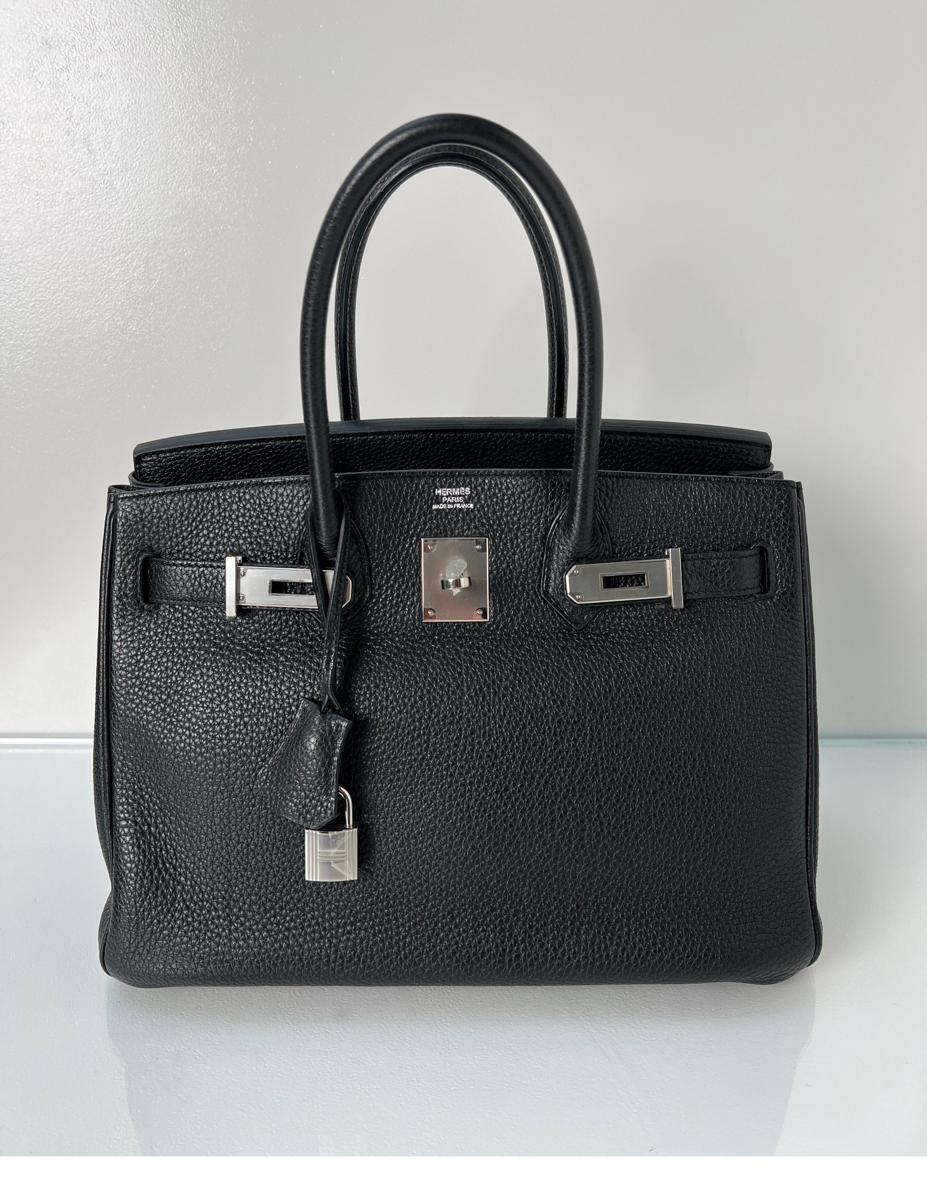 Hermes Black Birkin 30 Bag. Excellent condition like new. The bag looks like it was never carried. Togo leather. Palladium silver hardware. Interior clean. Plastic is still on the hardware. Most wanted size 30 Birkin. Includes clochette, lock, keys,