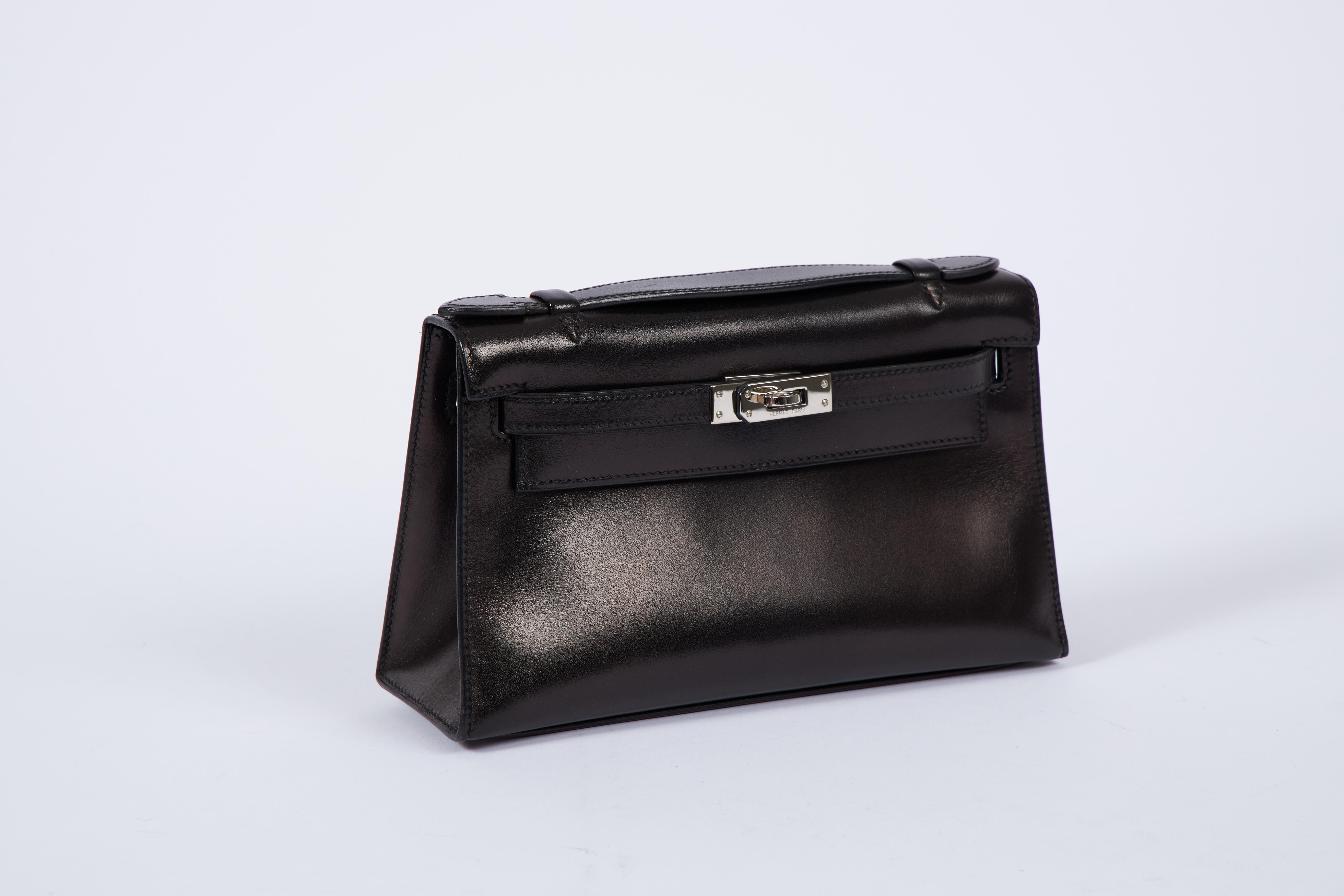 Hermes black box calf Kelly couchette with palladium hardware. Partial plastic on hardware. Date stamp J, 2006. Comes with original dust cover.