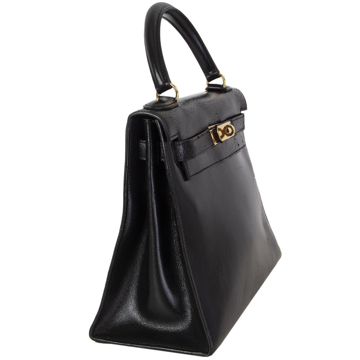 Hermes 'Kelly l 28 Sellier' bag in black Veau Box leather. Vintage 1970. Lined in leather with two open pockets against the front and an open pocket against the back. Has been carried and shoulders show dryness, minimal wear to the corners, the