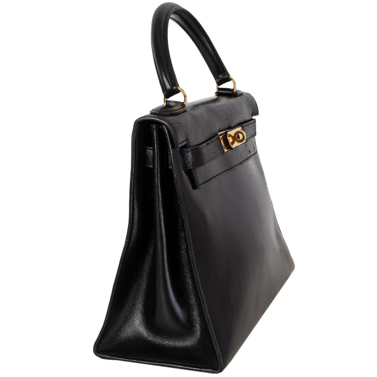 Hermes 'Kelly l 28 Sellier' bag in black Veau Box leather. Vintage 1970. Lined in leather with two open pockets against the front and an open pocket against the back. Has been carried and shoulders show dryness, minimal wear to the corners, the