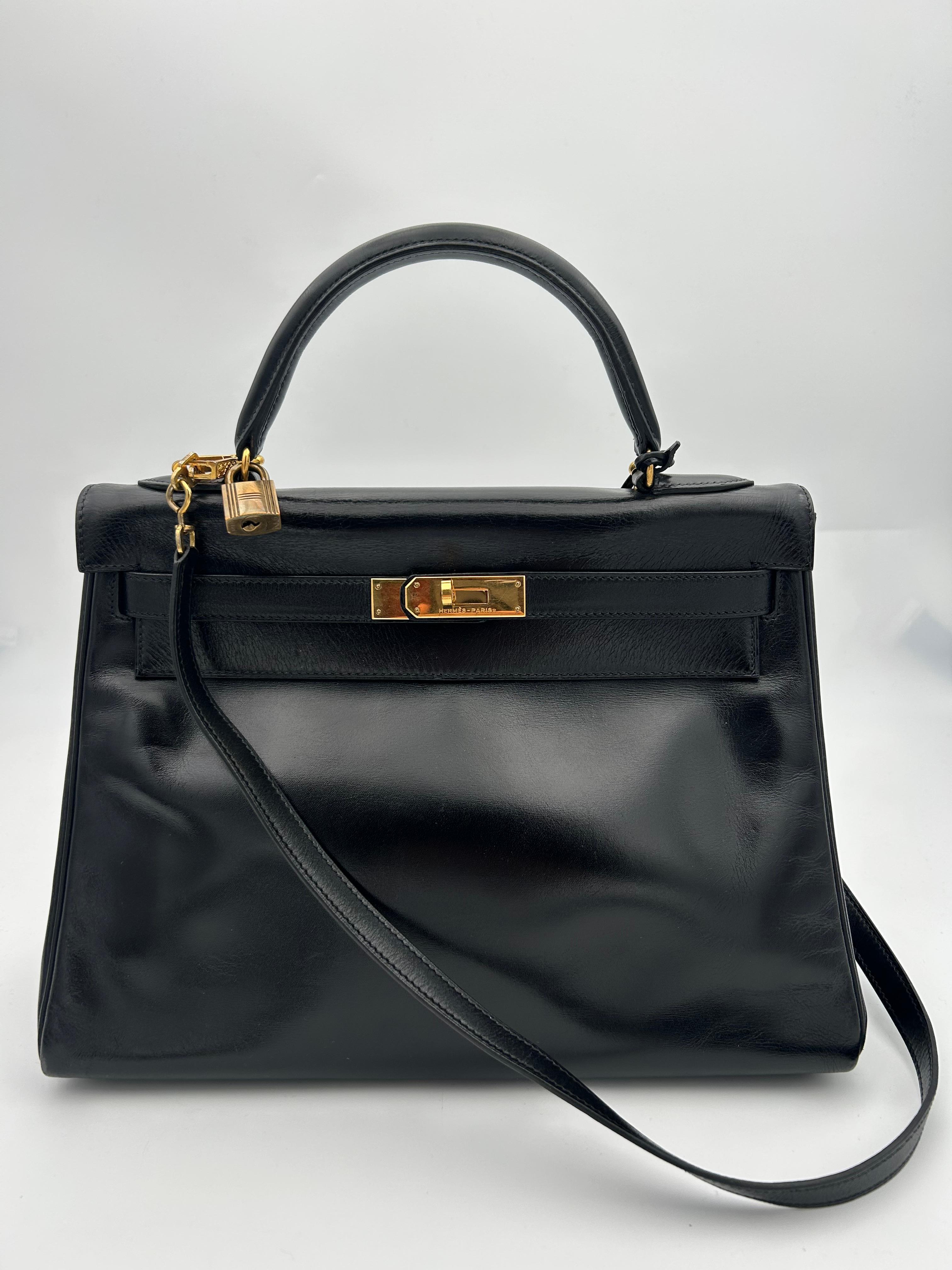 The 1998 Hermès Kelly bag in black Box leather is a timeless and iconic piece, exemplifying the brand’s dedication to impeccable craftsmanship and understated luxury. Made from Box calf leather — a smooth, glossy material known for its structured