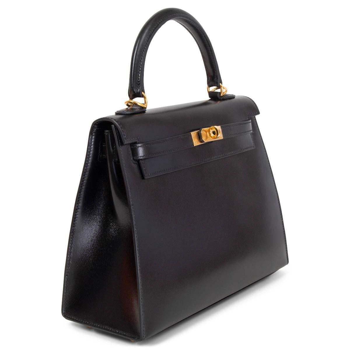 100% authentic Hermès Kelly 25 Sellier Bag in Noir (black) Veau Box leather featuring gold-tone hardware. Lined in Chevre (goat skin) with an open pocket against the front and a zipper pocket against the back. Brand new - Full Set. Comes with keys,