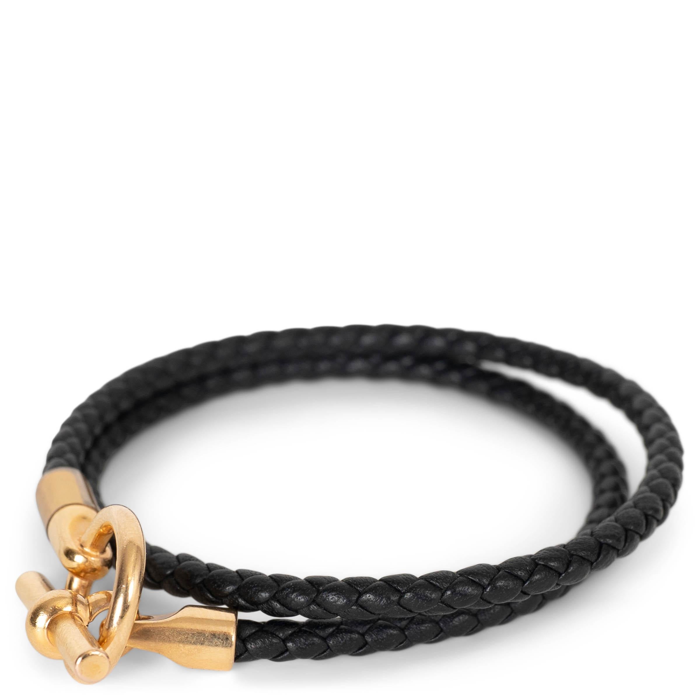 This 100% authentic Hermès braided double tour bracelet is crafted from black supple Swift calfskin and finished with the elegant Glenan closure. The design wraps twice around the wrist, showcasing Hermès’ impeccable craftsmanship and timeless