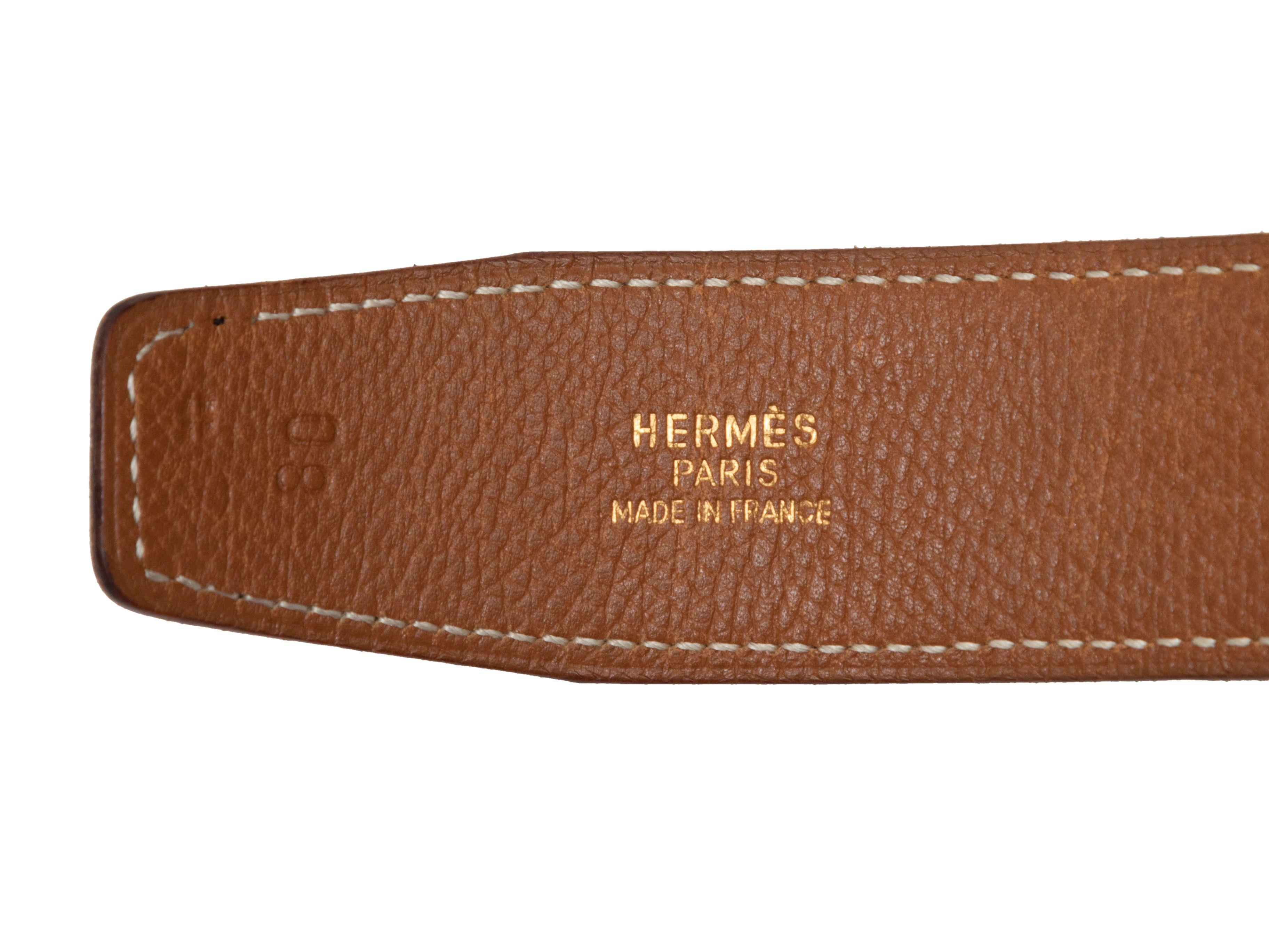 Product Details: Black and brown leather reversible belt by Hermes. Gold-tone hardware. Peg-in-hole closure. 1.25
