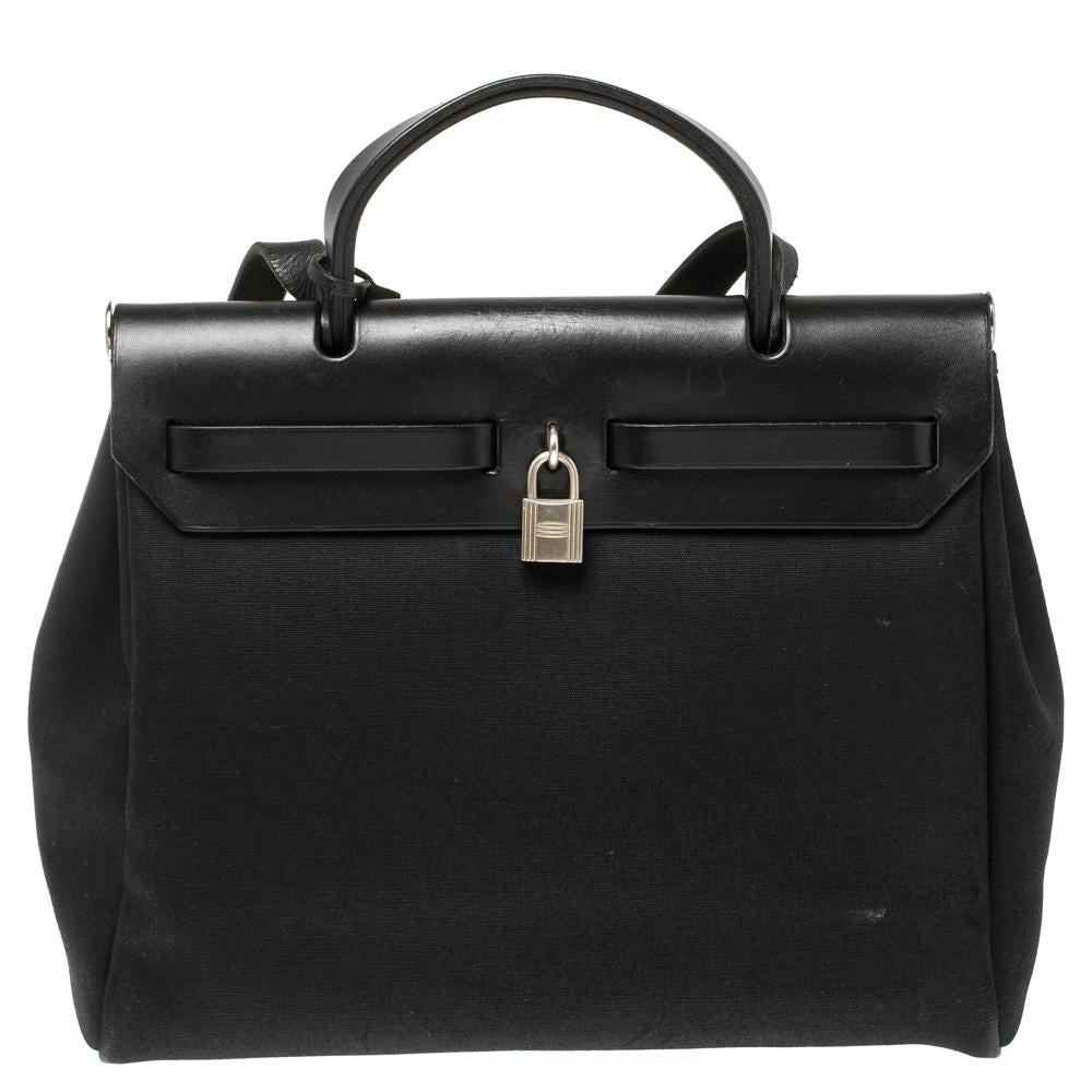 Made from black canvas and leather, the Herbag Zip 31 is just as outstanding as all of Hermès' other handbags. Made in France, the creation comes with a single handle, a long shoulder strap, and a spacious interior to house your essentials. Complete