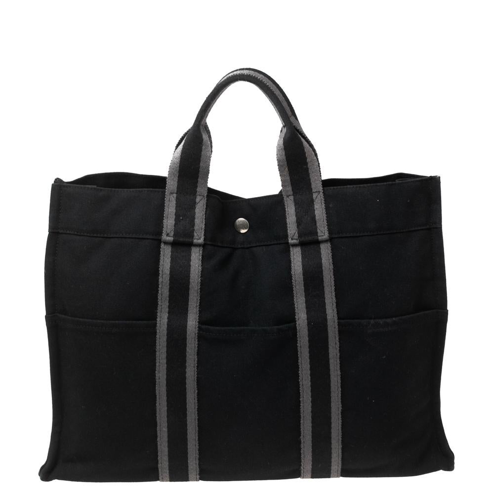Known for their exceptional and upscale creations, the House of Hermés is back with yet another classy design. This Fourre Tout MM tote bag is designed using black canvas on the exterior and flaunts a capacious fabric-lined interior space. It is