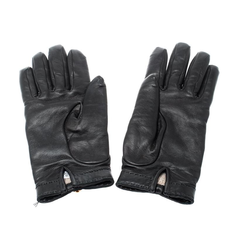 A truly stellar addition to your closet would be these gloves from Hermes. They've been meticulously crafted from lambskin leather and styled with gold-tone metal detailing. The black gloves are complete with cashmere lining.

