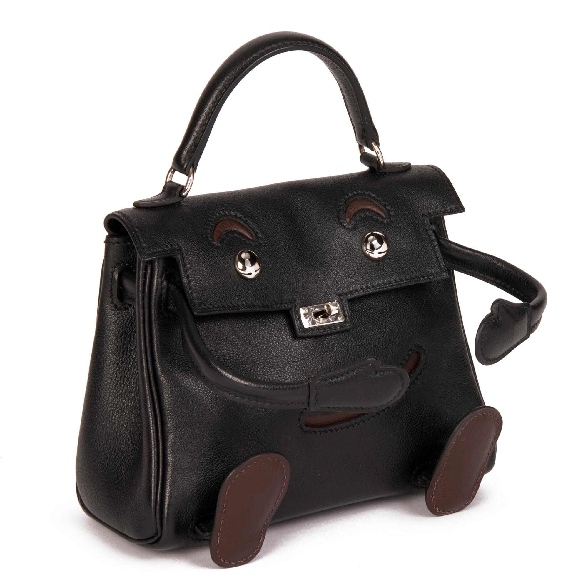 HERMÈS
Black & Chocolate Gulliver Leather Vintage Kelly Quelle Idole Doll

Serial Number: [D]
Age (Circa): 2000
Accompanied By: Hermès Dust Bag, Box
Authenticity Details: Date Stamp (Made in France)
Gender: Ladies
Type: Top Handle

Colour: Black,
