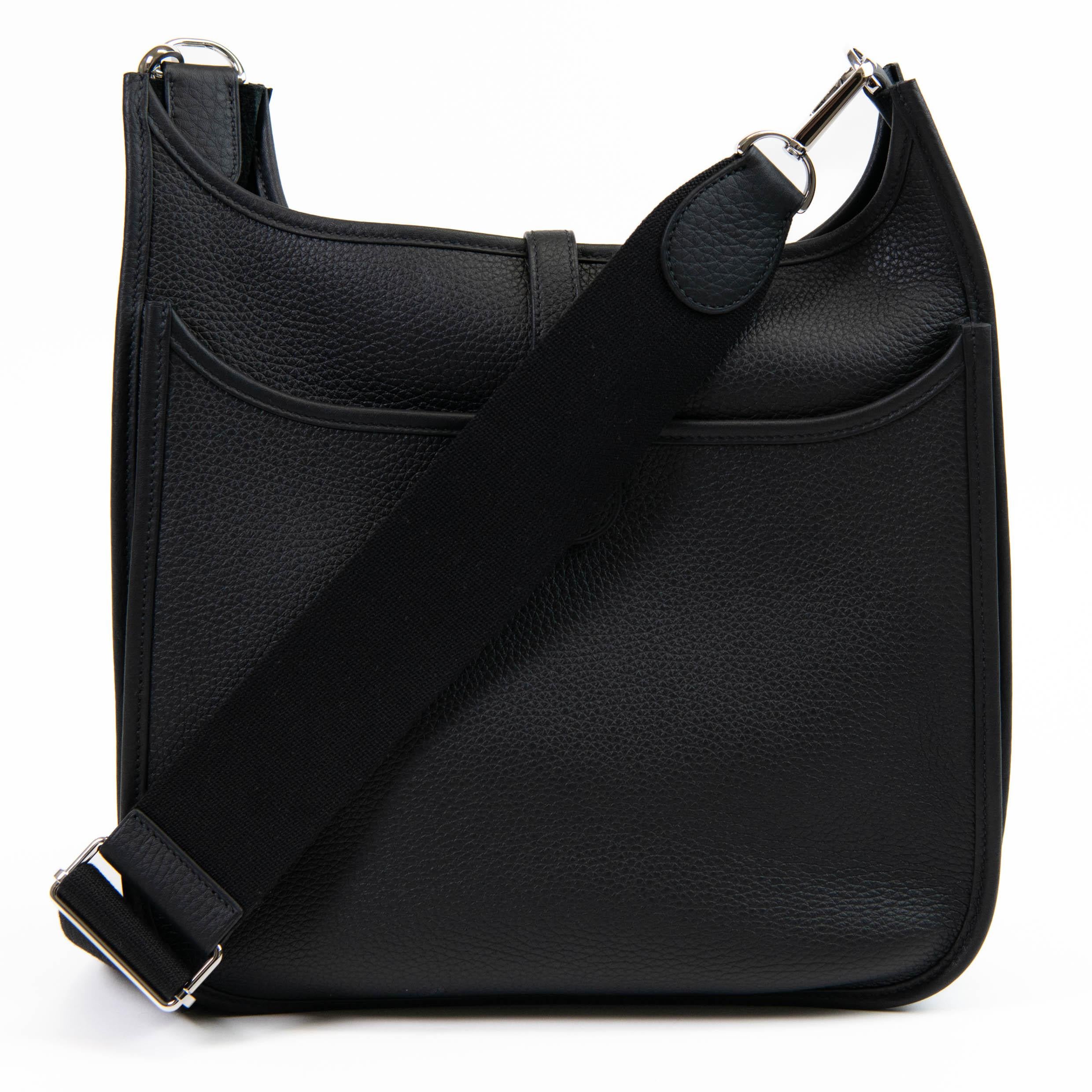 100% Authentic

This Evelyne is in Black Clemence leather with palladium hardware and has tonal stitching, pull tab top closure and Black removable canvas and leather shoulder/crossbody strap.

The interior is lined with natural leather.

11.5