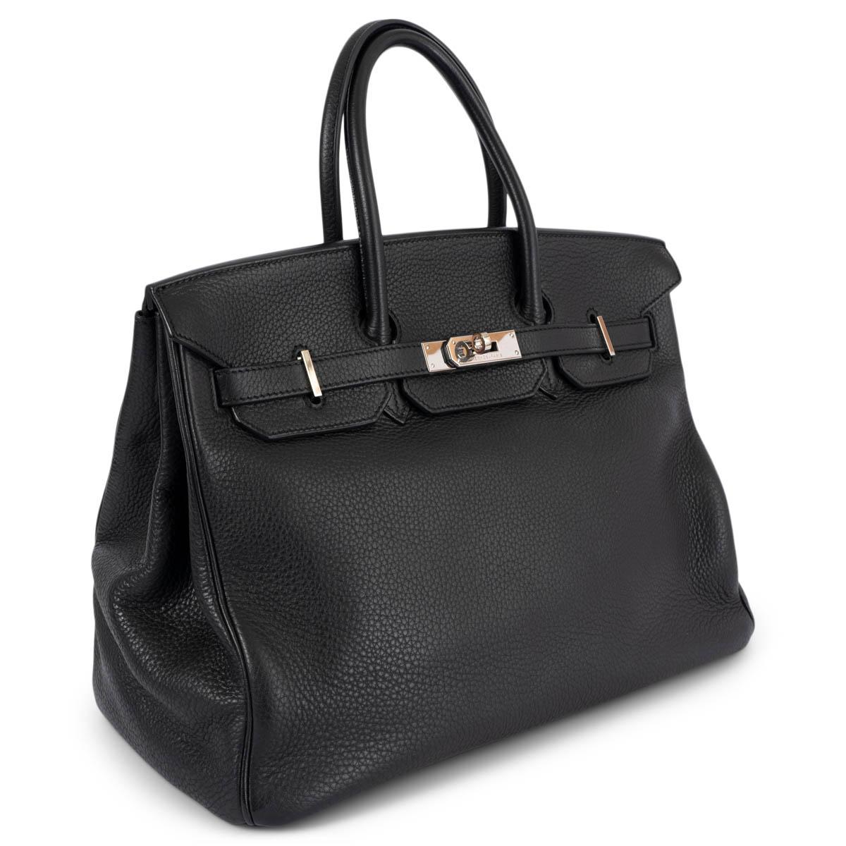 100% authentic Hermès Birkin 35 bag in black Taurillon Clemence leather with palladium hardware. Lined in Chevre (goat skin) with an open pocket against the front and a zipper pocket against the back. Has been carried and shows some scratches to the