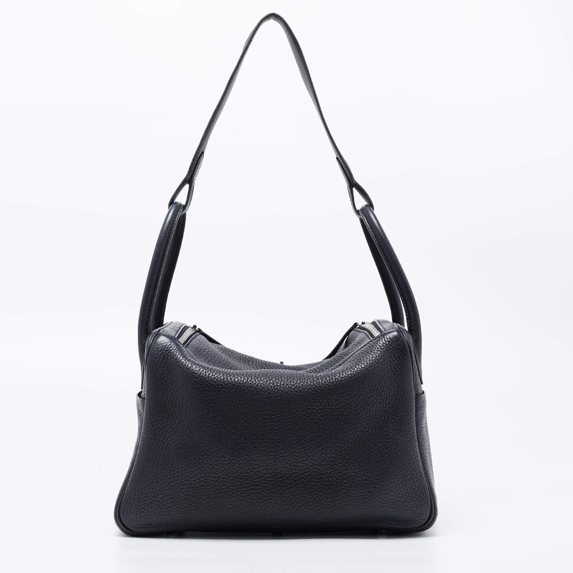 The Hermes Lindy was first designed in 2006, and it is recognized worldwide for its relaxed design. A creation of excellent craftsmanship, the Lindy sweetly embodies ladylike elegance! Exquisitely crafted from black Clemence leather, the bag has