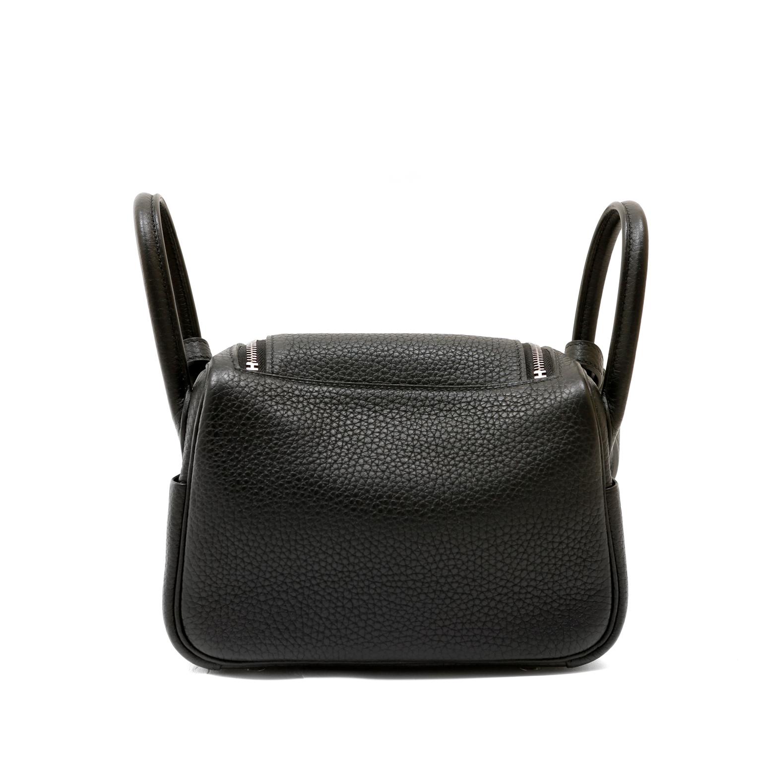 This authentic Hermès Black Clemence Mini Lindy is brand new with the protective plastic on the hardware.  In very high demand, the Mini Lindy is an instant classic in black leather with palladium hardware.
Double handles with a long cross body