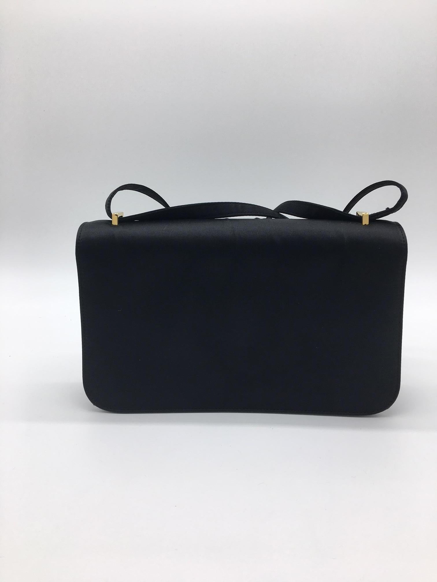 The Constance is undergoing a revival at the moment, the trend for small bags means that it is hugely in demand and we have several leather versions available. This, however is an incredibly rare and unusual Vintage Constance in black Silk with Gold