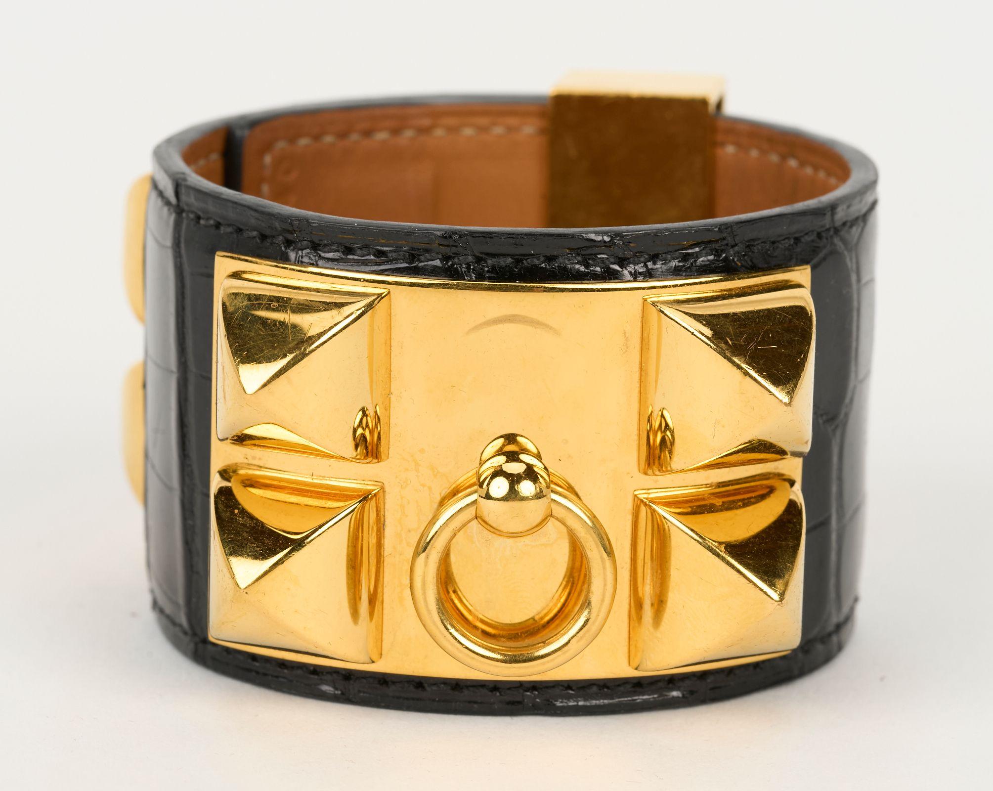 Hermès Collier De Chien Bracelet made from Mississippiensis alligator black leather with an adjustable closure and gold tone hardware. Very little wear on interior leather and tiny marks on gold hardware. Date stamp P, 2012. Size small. Comes with