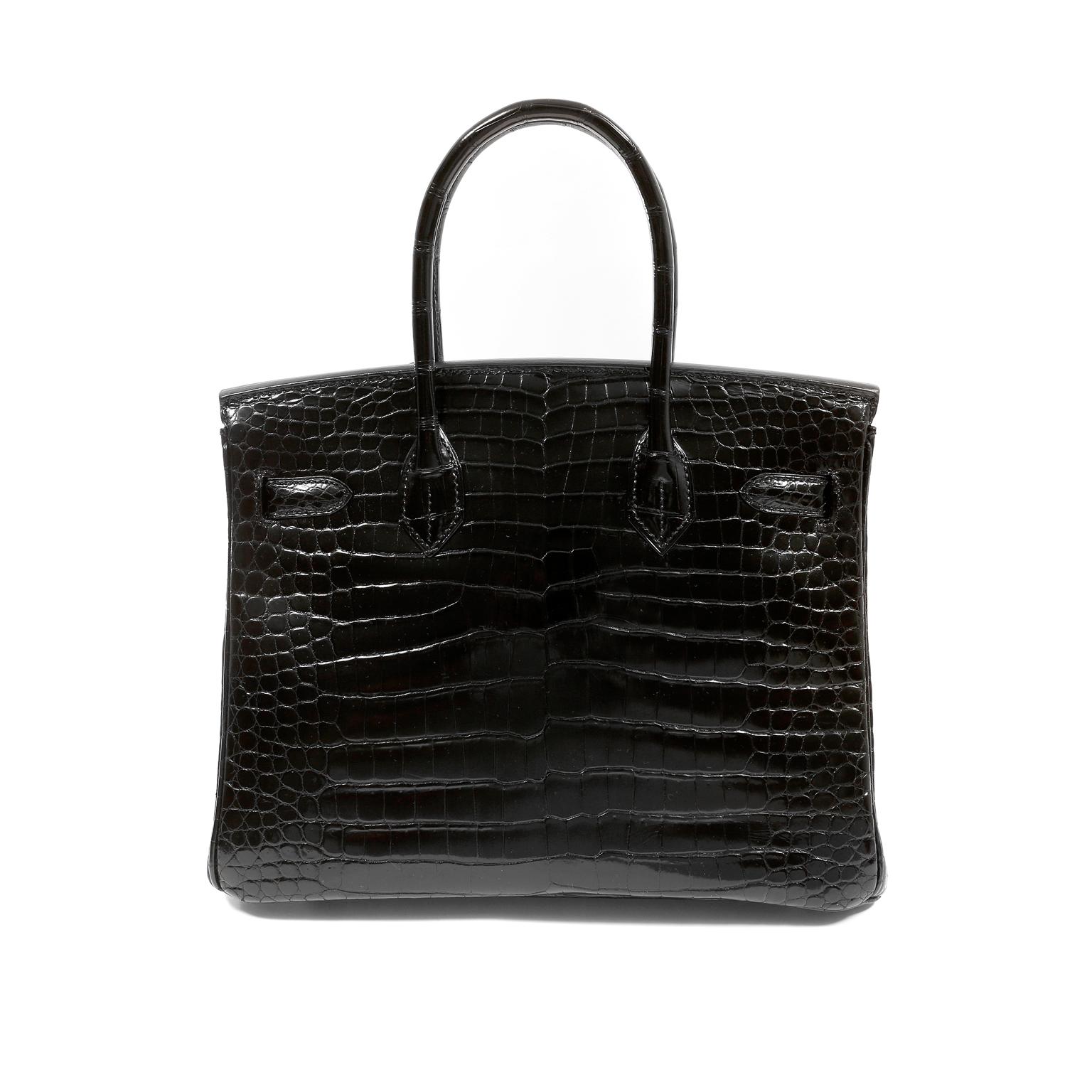 This authentic Hermès Black Crocodile 30 cm Diamond Encrusted Birkin is in pristine condition.    Incredibly rare and specially ordered, this exotic Birkin is perhaps the most collectible of all.
Black shiny crocodile skin showcases every detail